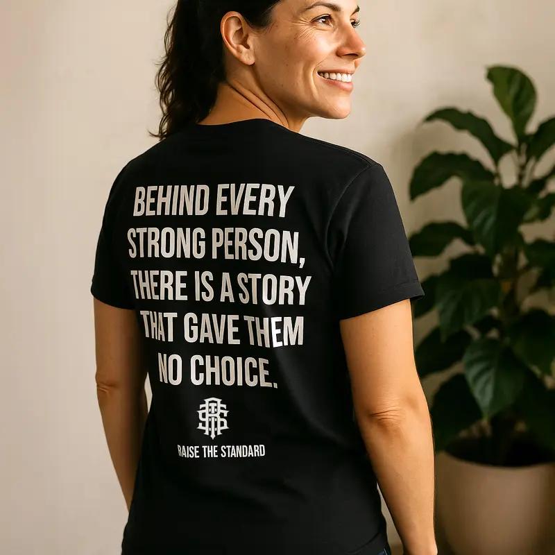 RAISE THE STANDARD Behind Every Strong Person Soft Fabric Unisex T-Shirt, Birthday Gift, Casual, Menswear, Trendy Shirt, Graphic Tees, Streetwear