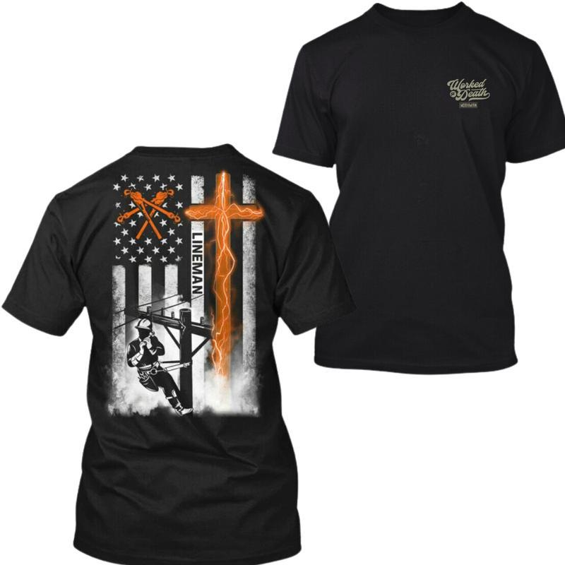 Lineman American Flag Tshirt for Men Black cotton tee with lineman climbing power pole, glowing orange cross and USA flag, bold Christian workwear gift for electricians, Graphic Print T-Shirt