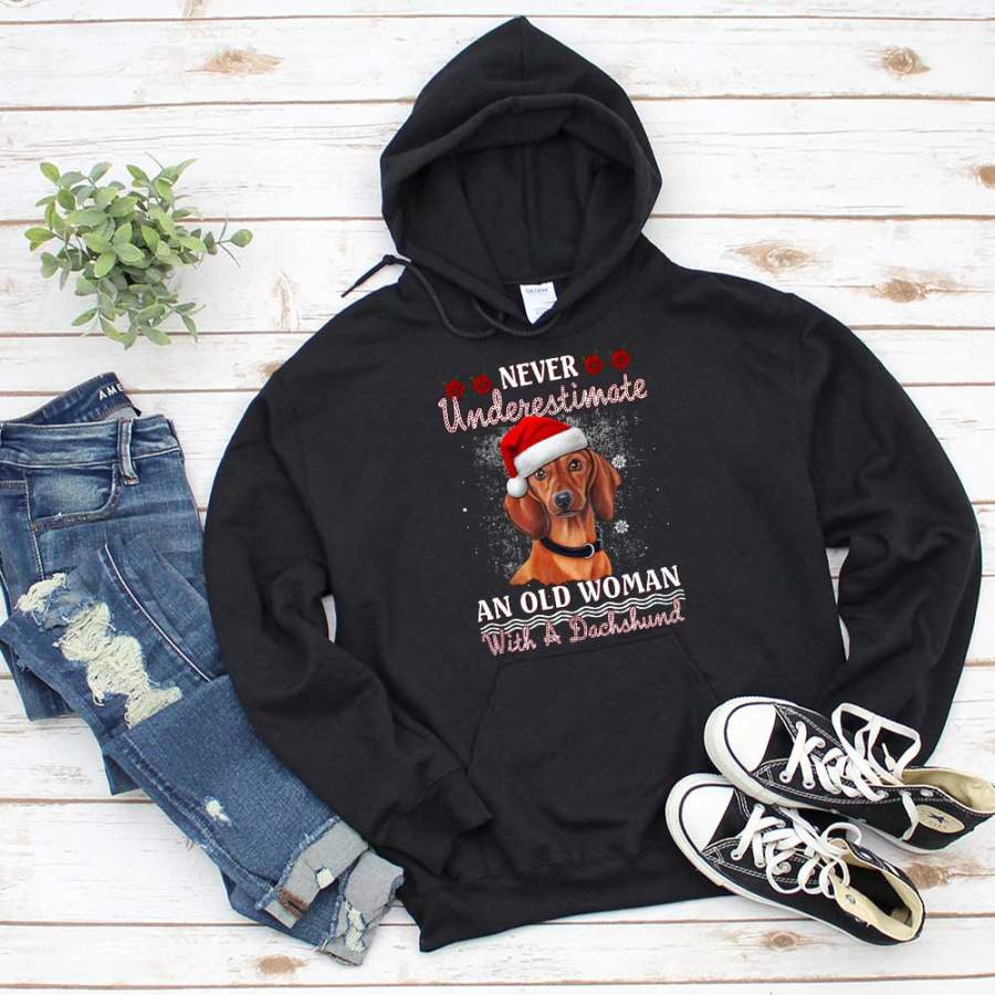 Dachshund christmas never underestimate snow santa hat poinsettia flower winter season black hoodie for men and women S-5XL